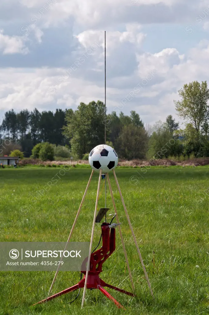 A model rocket made from a soccer ball sits on a launch platform at a rocketry launch event in east King County.