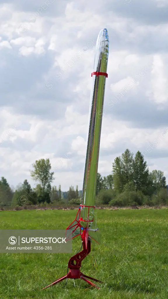 A large silver rocket on a platform ready to launch, at a model rocketry launch event in east King County.