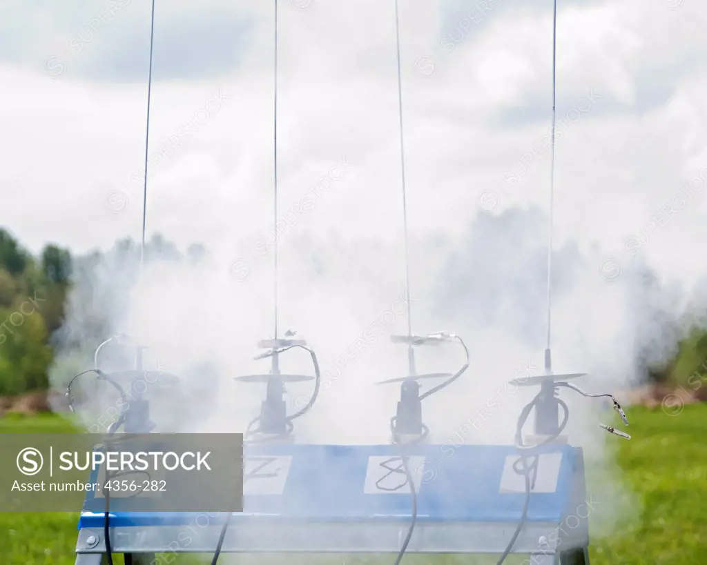 Smoke still swirls around four launch pads at a model rocketry launch event in east King County.