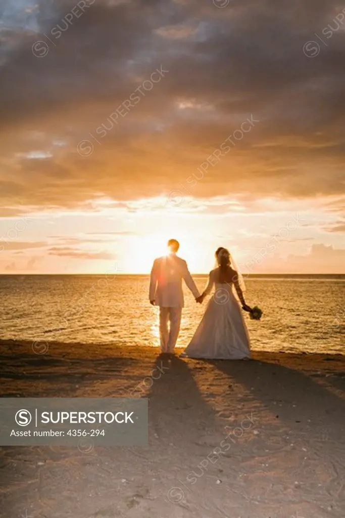 Jamie Spritzer and Seth Resnick on the beach at sunset on the island of Nevis, just after their wedding.