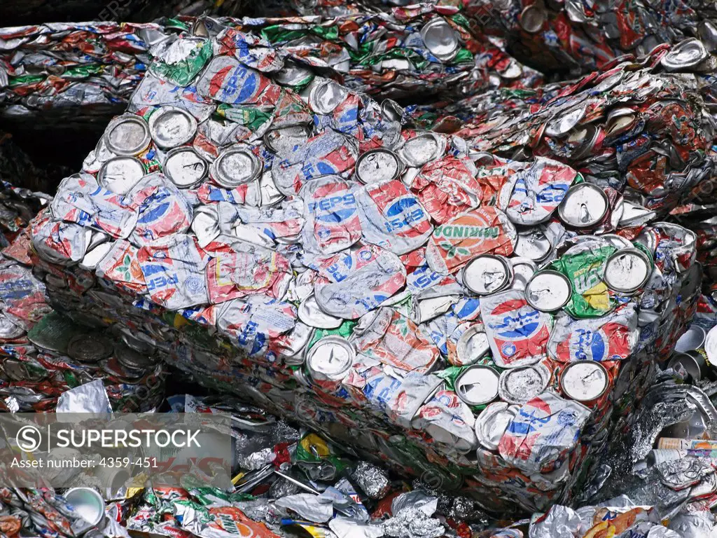 Crushed aluminum cans ready for recycling are packed in bales.