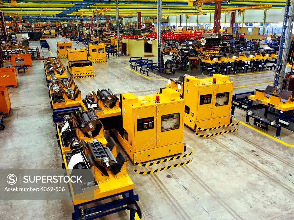 Robotic transport is used in a mechanical engineering plant. Automatic guided vehicles (AGV) are carrying materials to the next stage of production