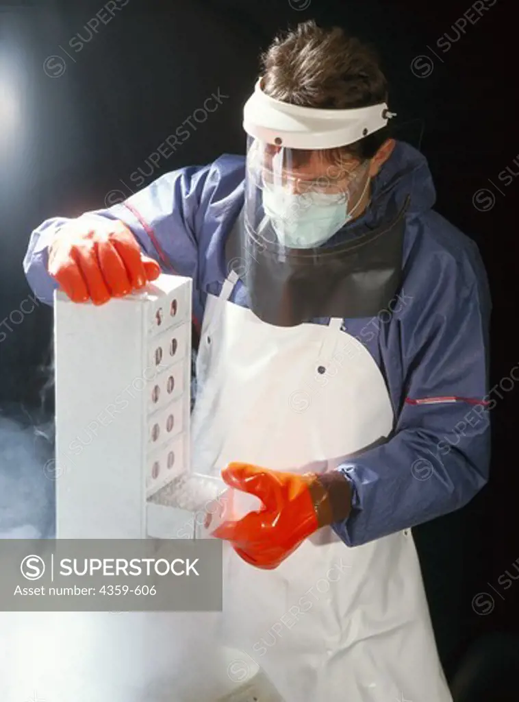 Researcher taking out cell cultures from a deep-freezing container