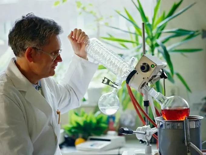 A chemical researcher using a rotary evaporator.