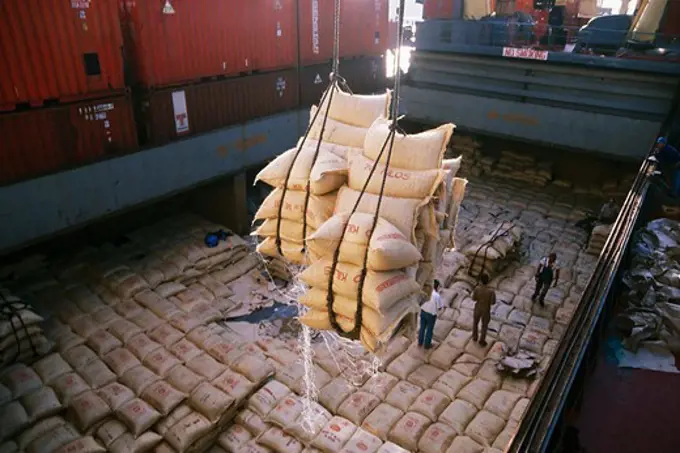 Unloading sacks of coffee from the cargo hold of a ship on a Hamburg dock.