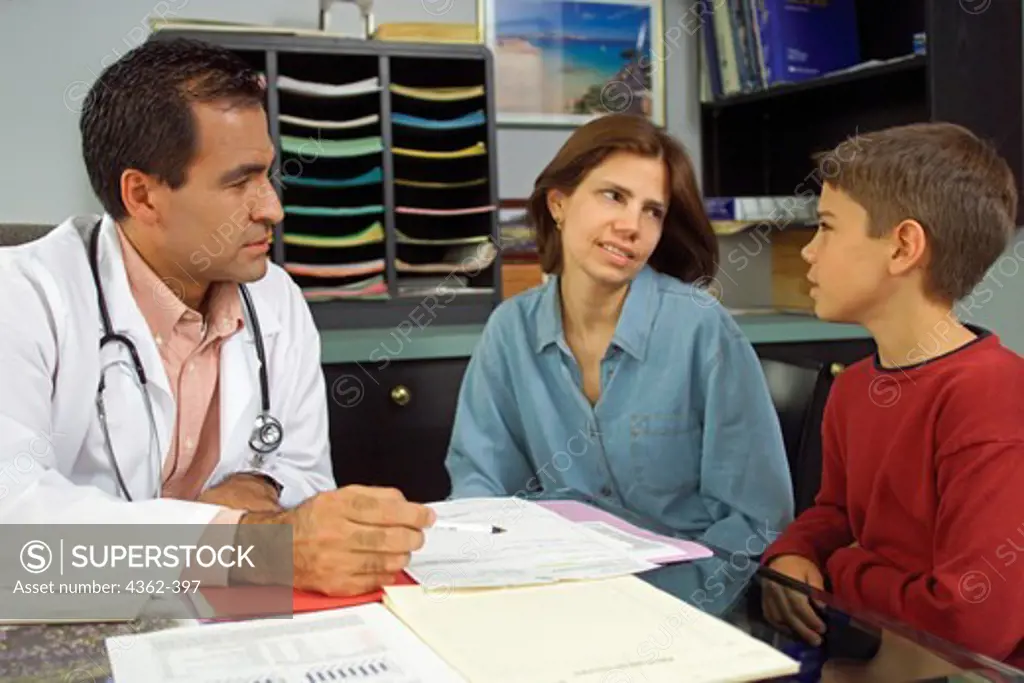 Mother and Son Consult with Pediatrician