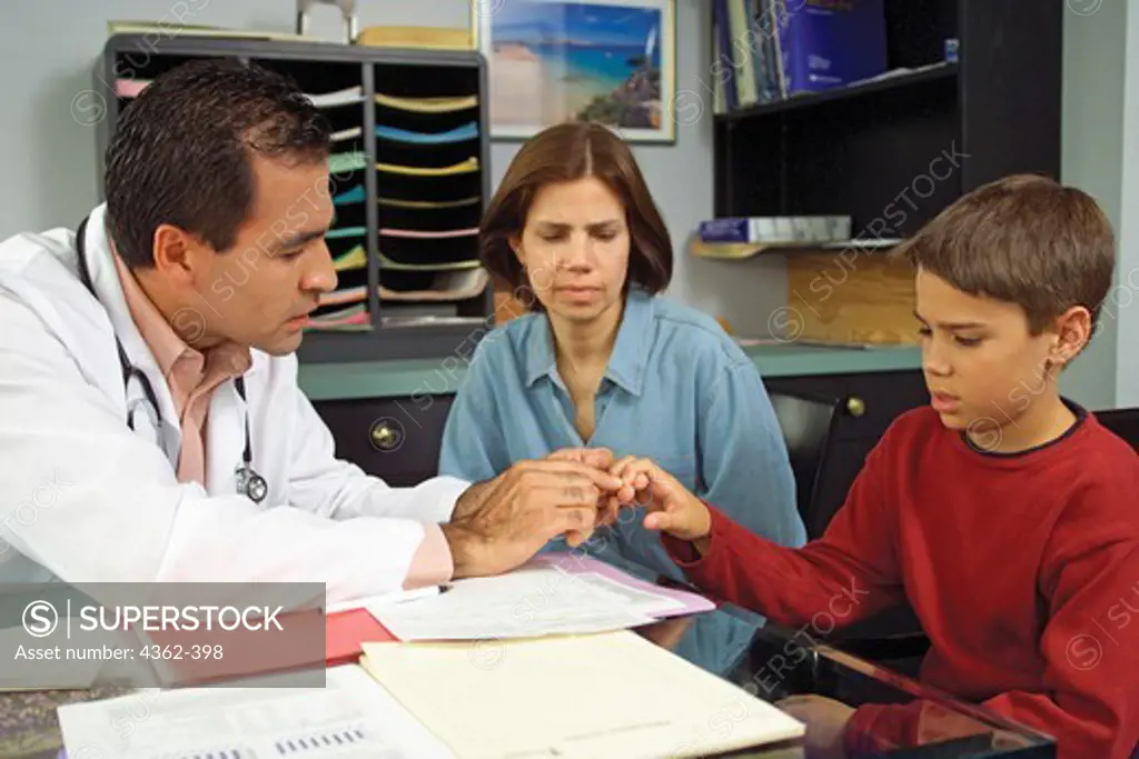 Mother and Son Consult with Pediatrician