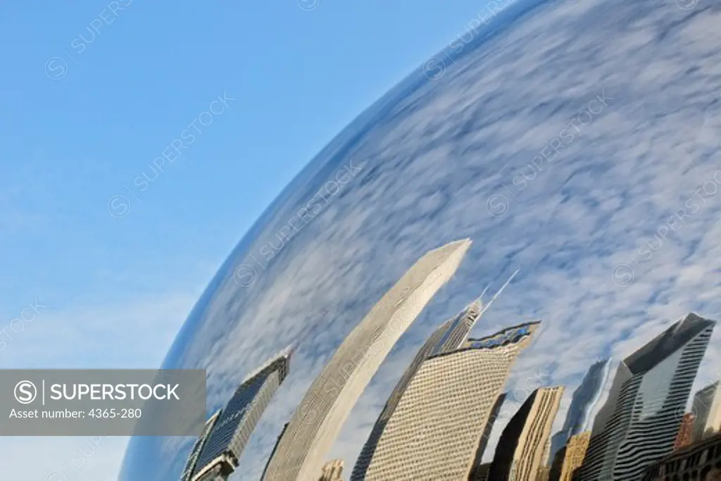 A reflection of the city skyline in the 'Cloud Gate' sculpture in Chicago's Millennium Park. The reflective sculpture is also known as The Bean because of its shape.
