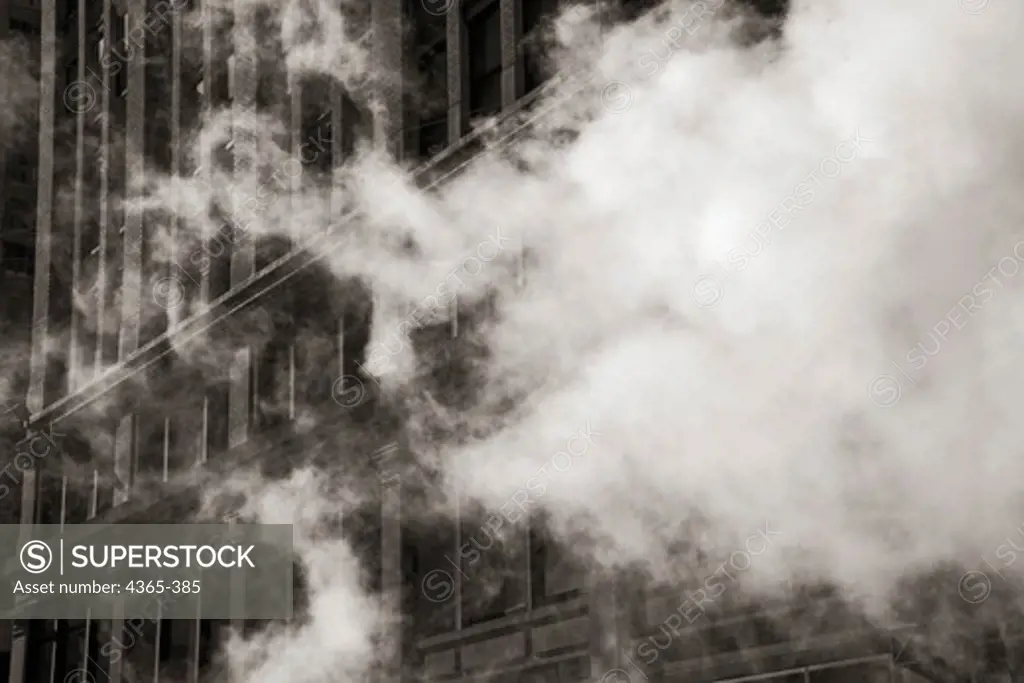 Steam floats across a view of a building.