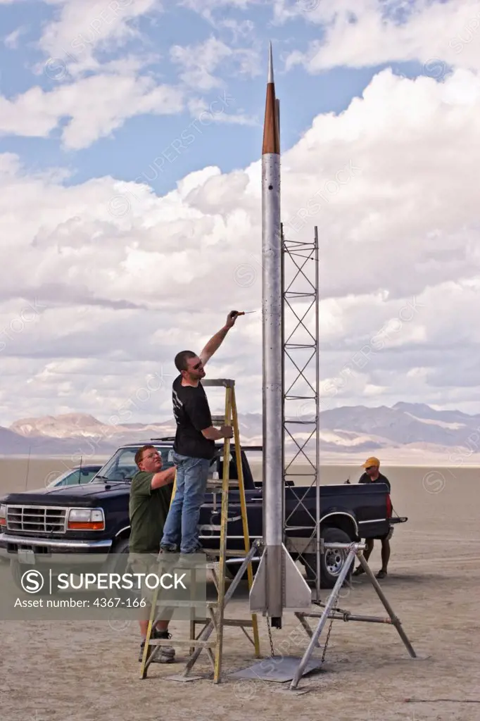 The crew of High Expectations prepares their rocket on its gantry at BALLS, an experimental rocketry event in the Black Rock Desert of northern Nevada.