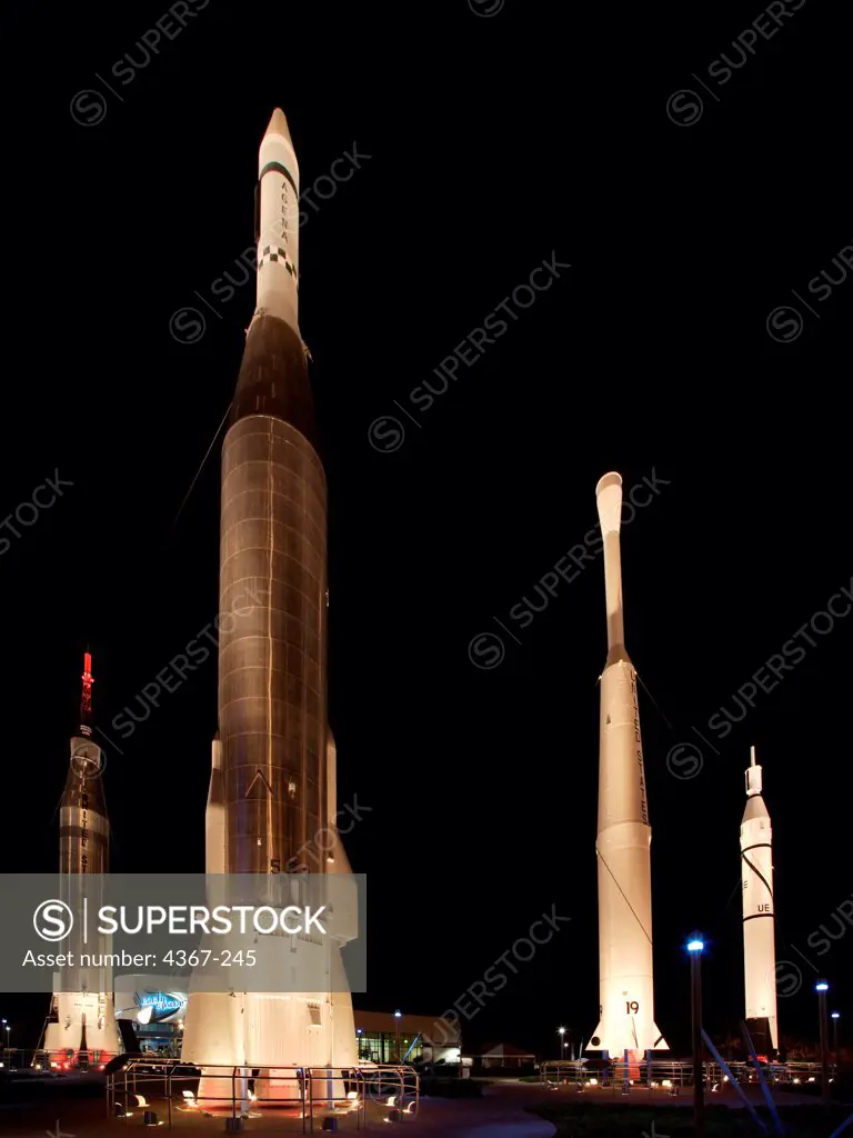 The Rocket Garden at the Kennedy Space Center Visitor Complex at night. On display are (l-r) a Mercury Atlas, Atlas Agena, Delta, and Juno I.