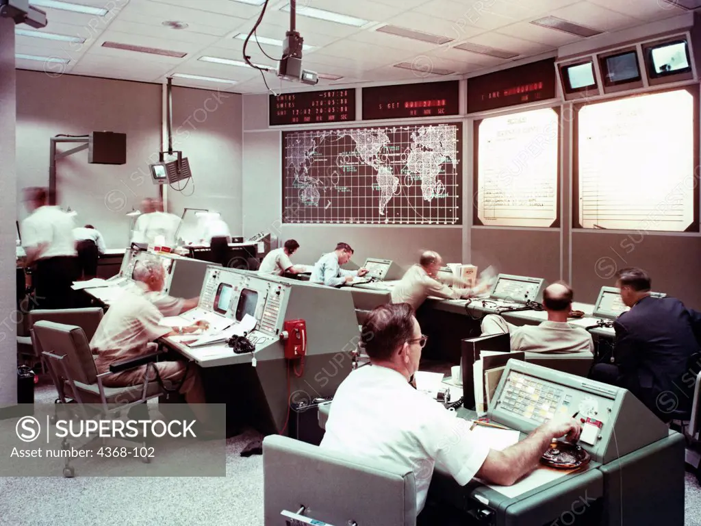 A view taken inside the recovery control room formerly at MSC (Manned Spacecraft Center) during a training session.  Screens show the tracking stations and recovery operations for one of the Gemini missions.
