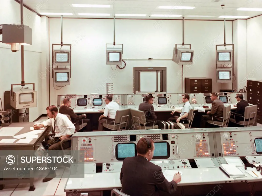 A view taken inside the staff support room (SSR), a support room for the MOCR (Mission Operations Control Room) used for scheduling, monitoring and directing network activities and readiness checks.  Responsibilities also include verifying remote site prepass equipment and directing network handover operations.