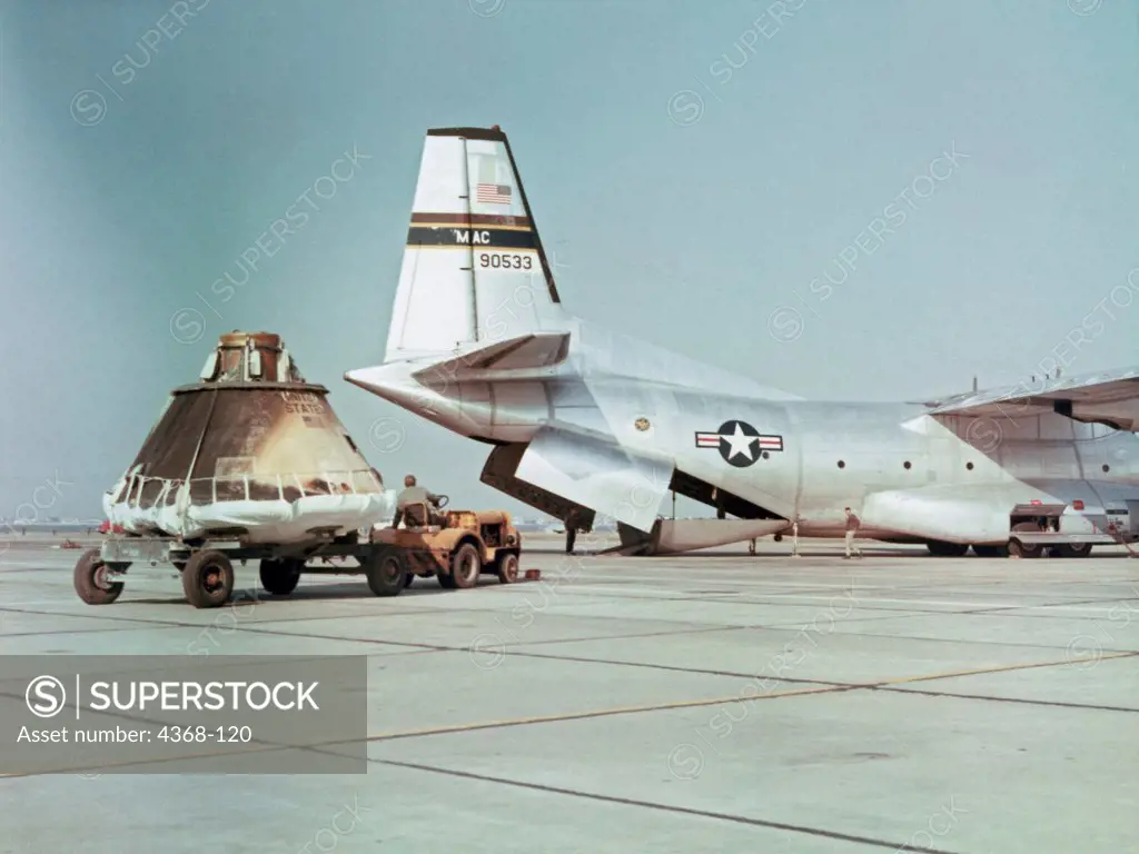 A Military Airlift Command C-130 aircraft prepares to load the flown AS201 command module for transport to the Manned Spacecraft Center, Houston, Texas for further review and tests after its February 1966 suborbital test flight.