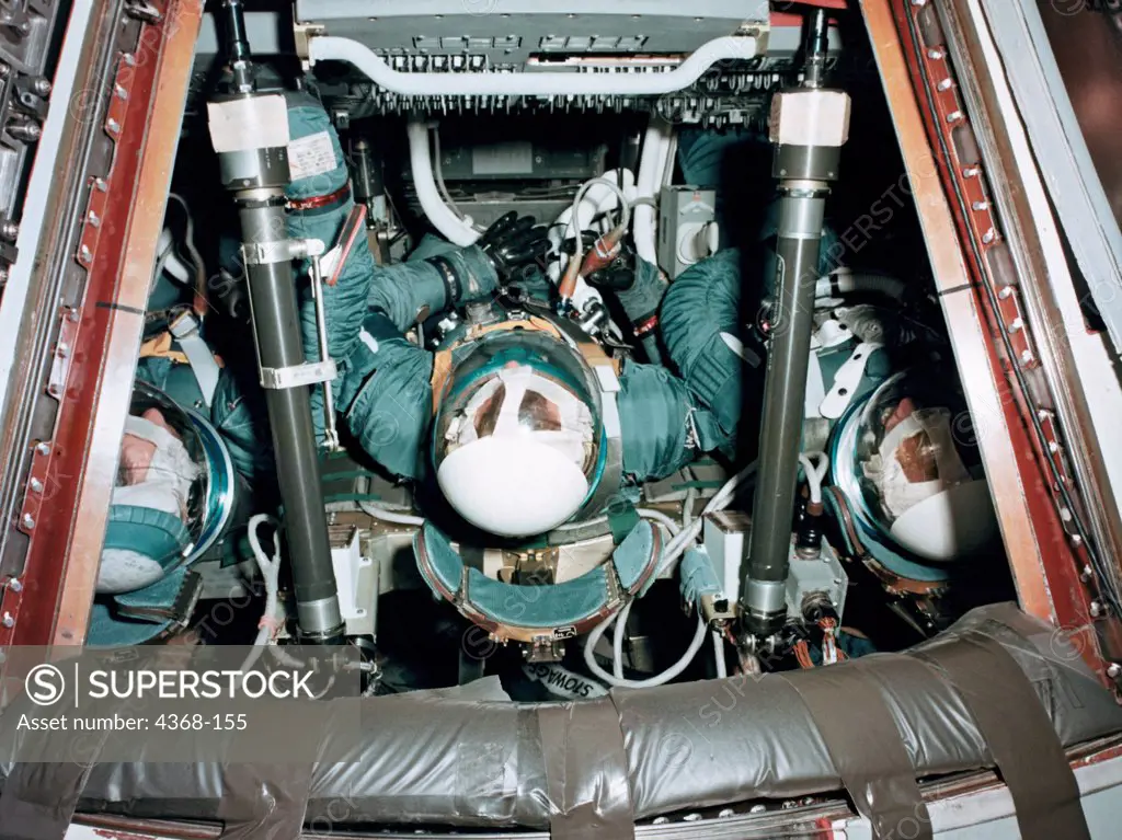 Three astronauts (later to be named the Apollo 9 prime crew) in Apollo spacecraft 101 Command module during Apollo crew compartment fit and function test. Left to right are Astronauts James A. McDivitt, David R. Scott, and Russell L. Schweickart