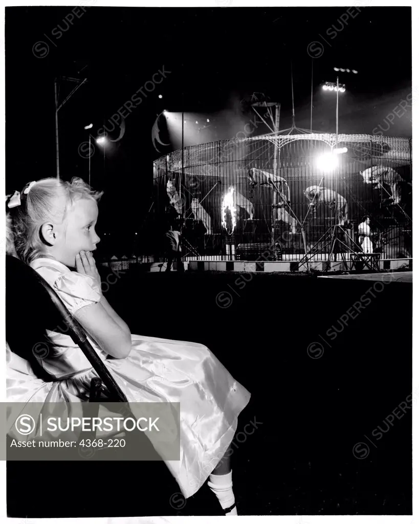 USA, Texas, Huston, Sam Houston Coliseum, Girl looking on in awe at wild animals in Shrine Circus, 1959