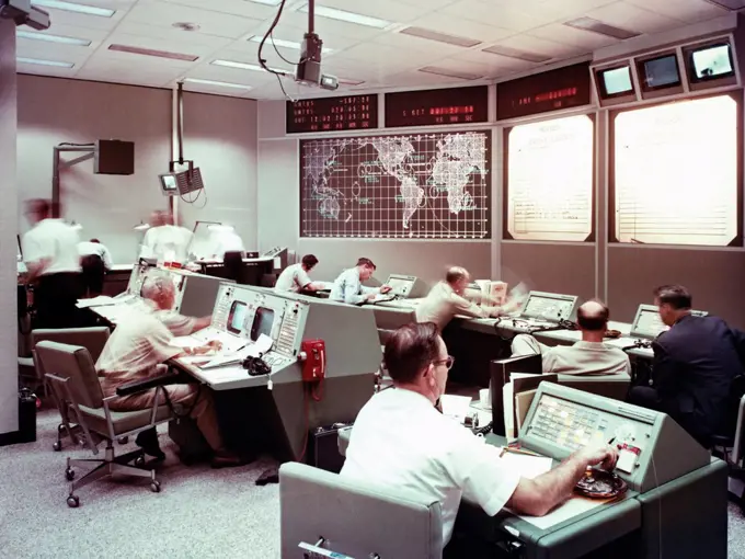 A view taken inside the recovery control room formerly at MSC (Manned Spacecraft Center) during a training session.  Screens show the tracking stations and recovery operations for one of the Gemini missions.