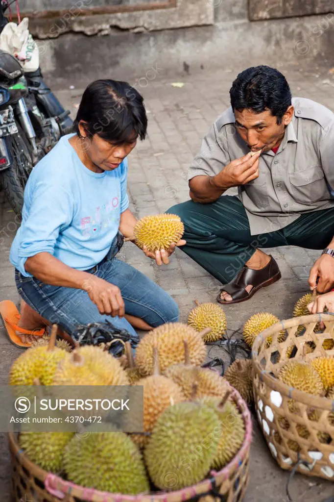 Indonesia, Bali, Ubud, Evening Market, People eating durian