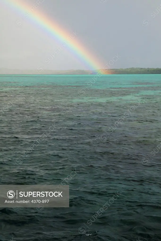 Micronesia, Caroline islands, Palau, Rainstorm and rainbow over ocean