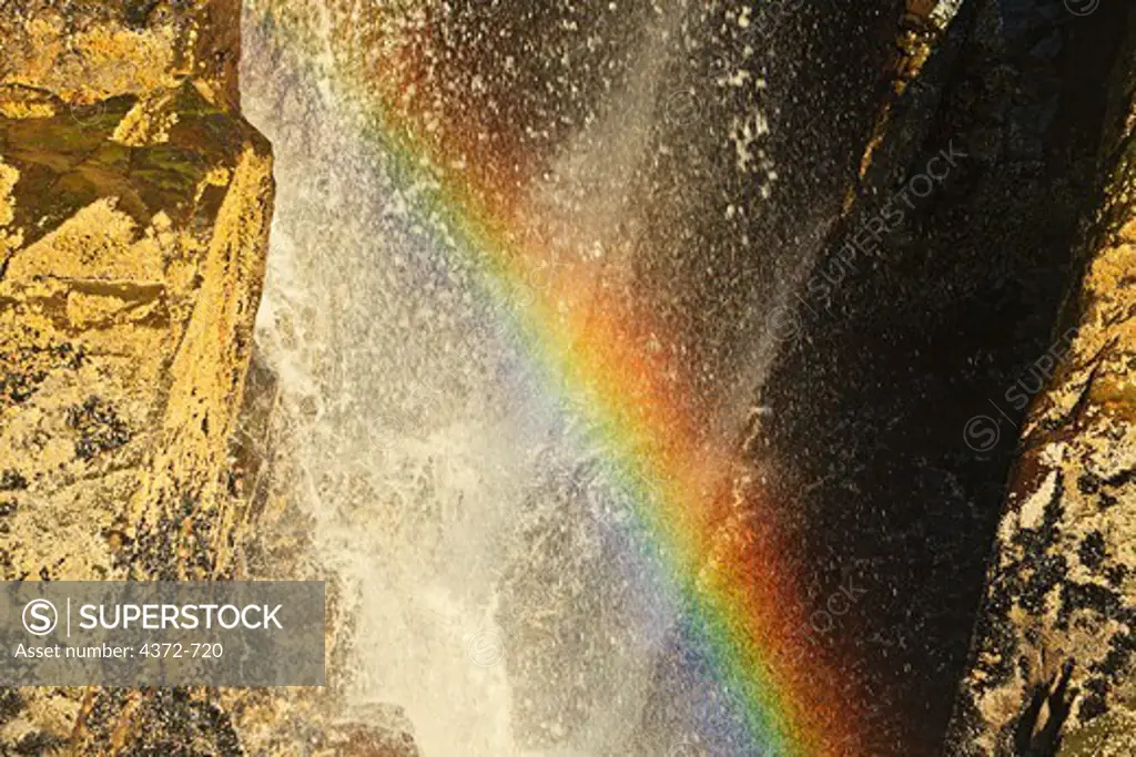 Rainbow in a snowmelt waterfall on Harriman Fjord, in the Chugach National Forest, Prince William Sound, Alaska.