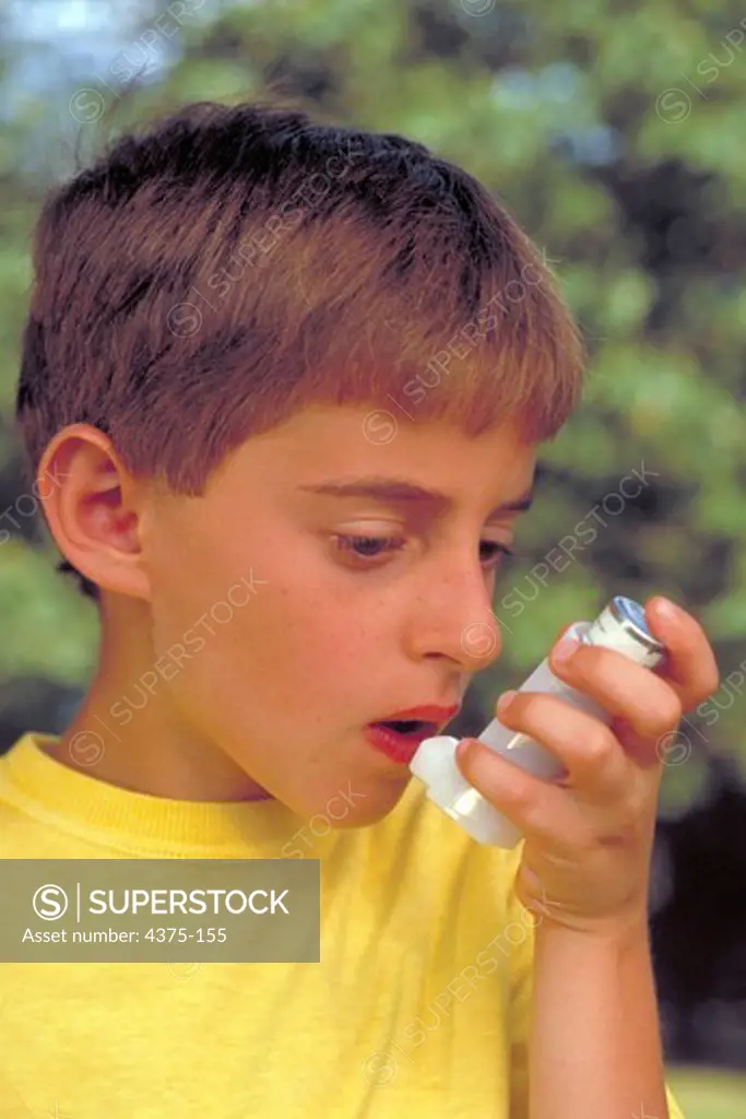 Young Boy Uses Inhaler to Treat Asthma