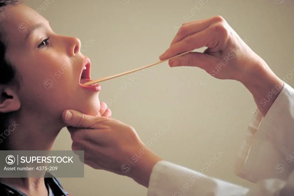 Pediatrician Examines Young Girl's Throat