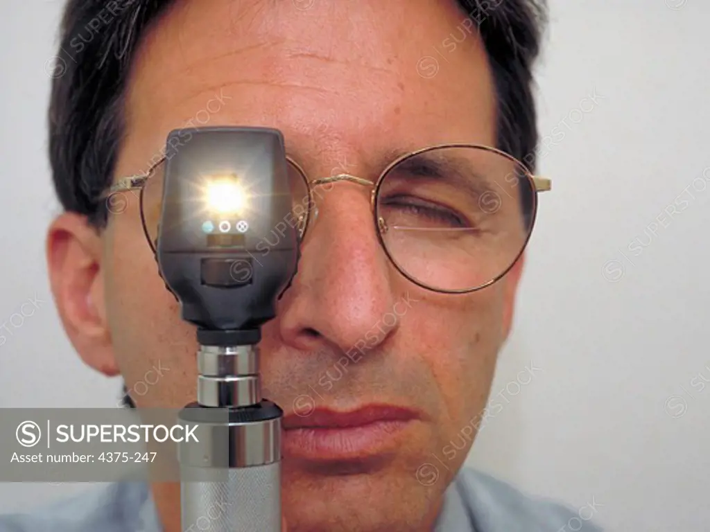 Ophthalmologist Peers Through Ophthalmoscope