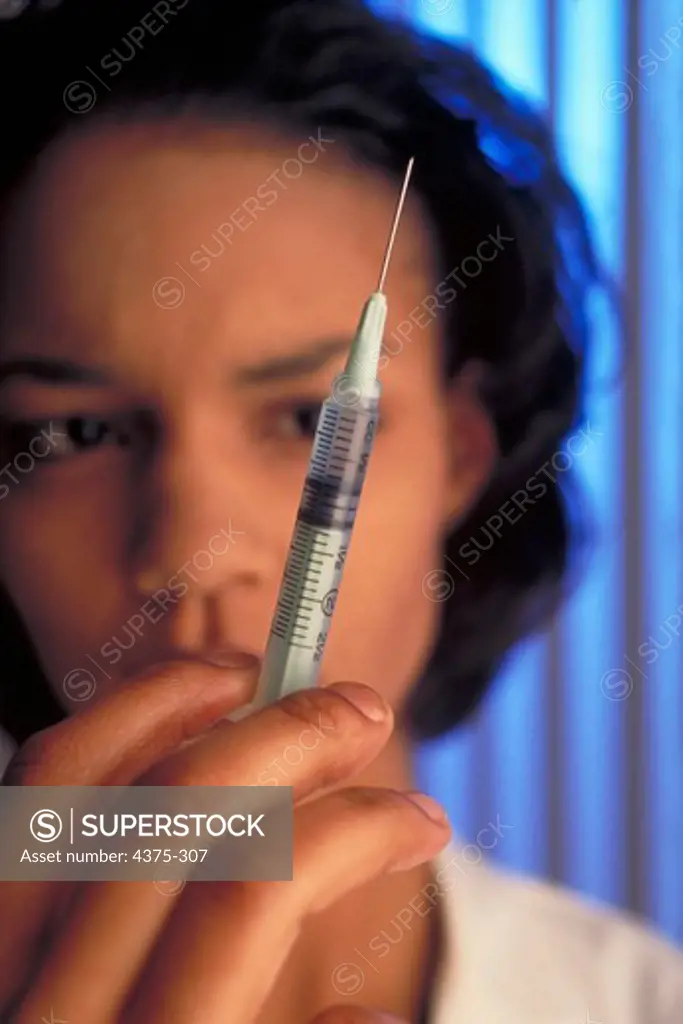 Young Female Doctor with Syringe