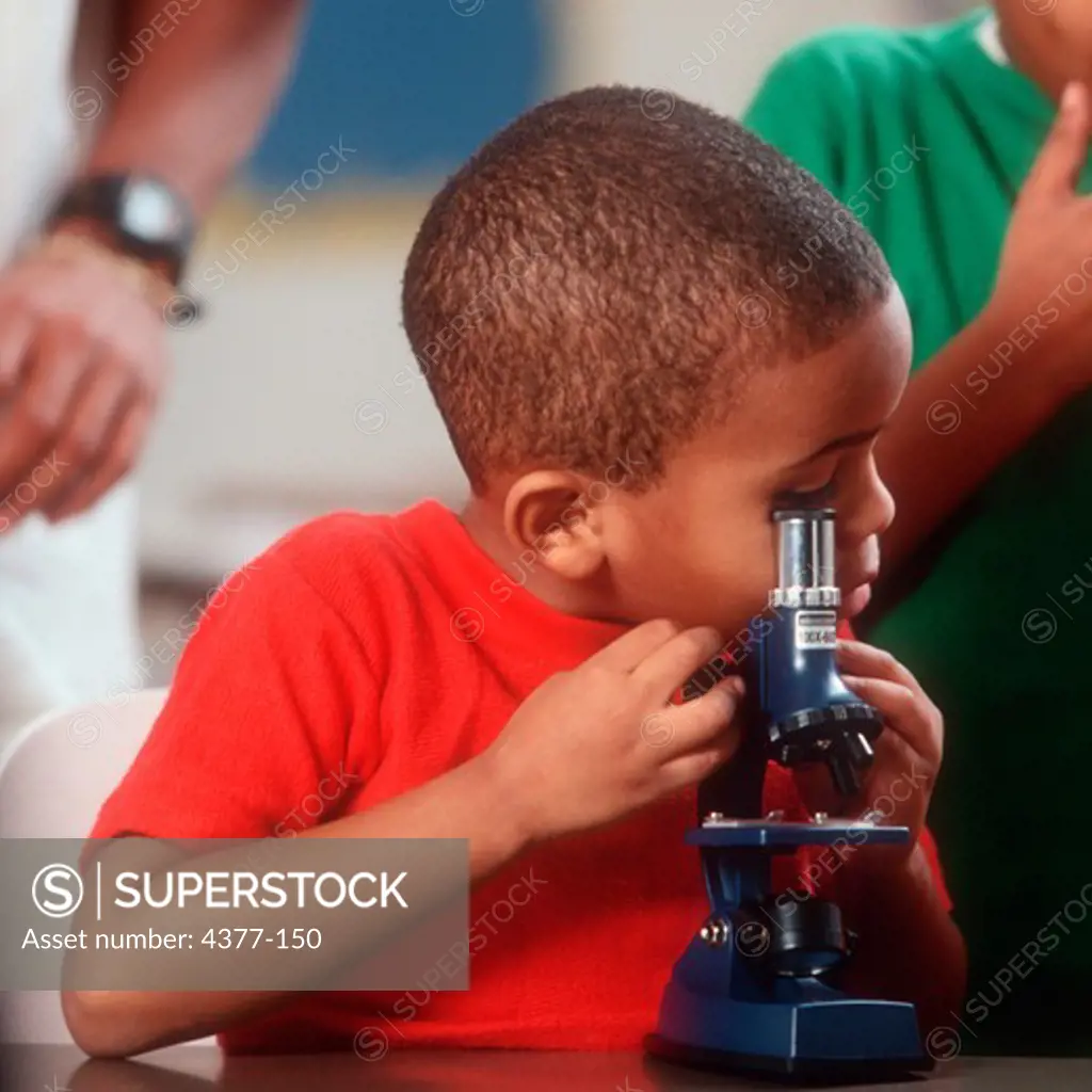 Child Looking into Microscope