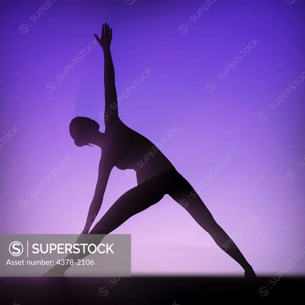 Silhouette of female body in triangle pose.