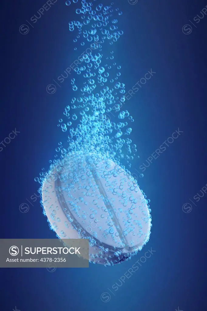 Aspirin surrounded by air bubbles to emulate the dissolution of a tablet in water.