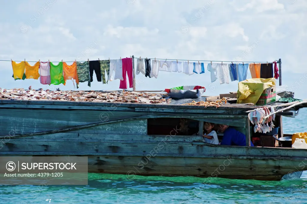 Laundry and Fish Drying in Sun on Bajau Boat