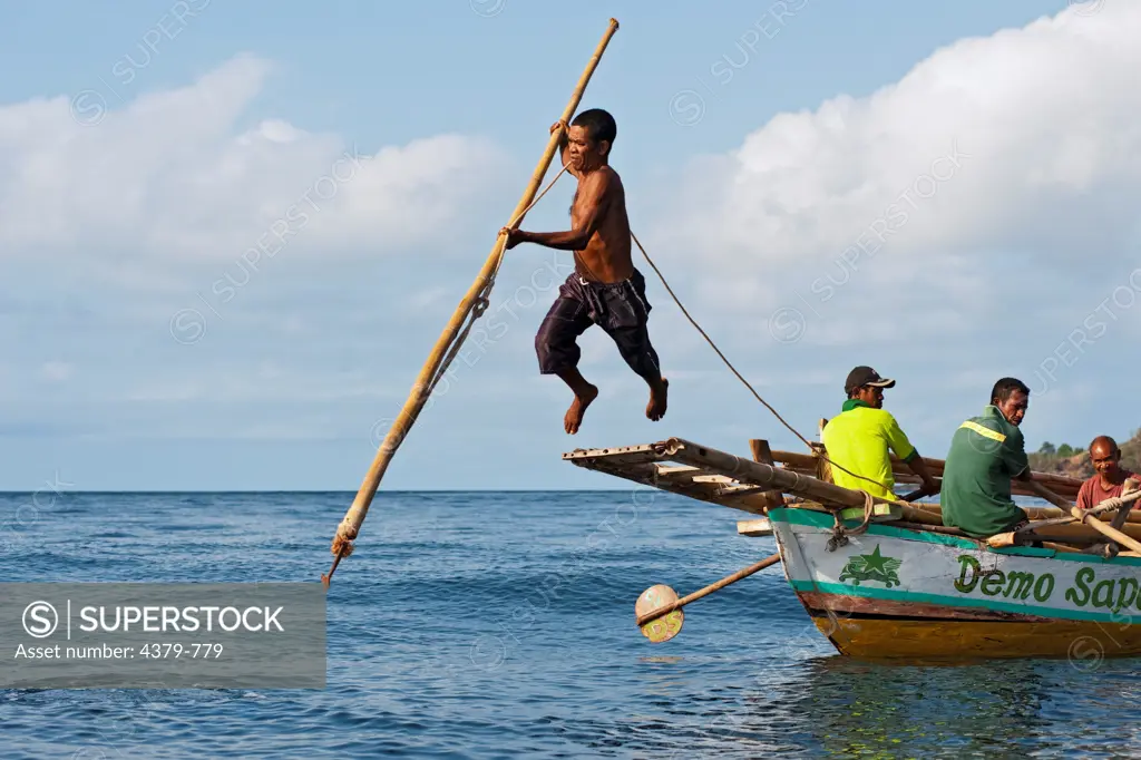 A traditional method of leaping from a boat platform to harpoon a whale, Lamalera, Lembata Island, Eastern Indonesia.