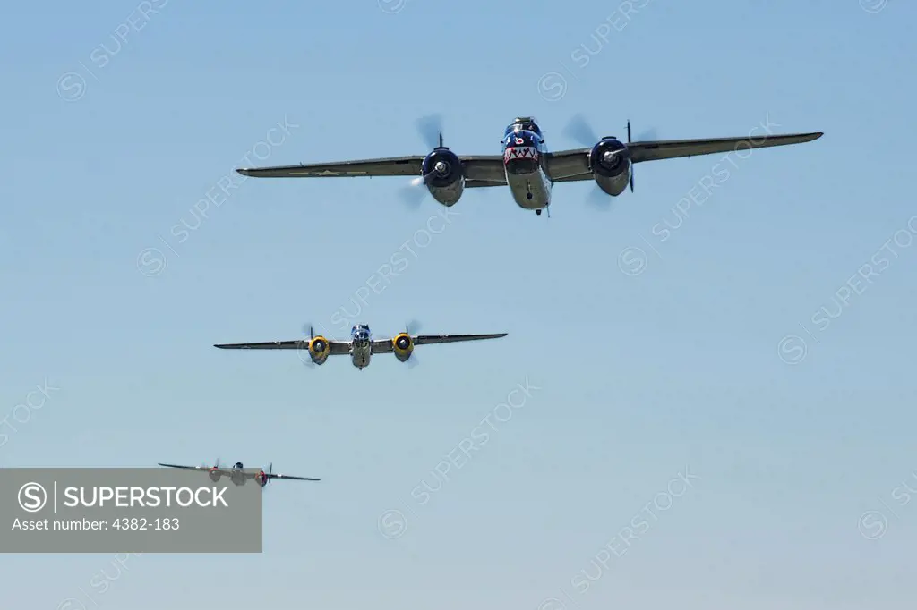 Three B-25 Mitchell bombers fly above the National Museum of the U.S. Air Force at Wright-Patterson Air Force Base, Ohio, April 18, 2010. The flight commemorated Lt. Col. Jimmy Doolittle's squad of 16 B-25s that bombed targets in Japan as a respond to the attack on Pearl Harbor. (Photo by Tech. Sgt. Jacob N. Bailey)