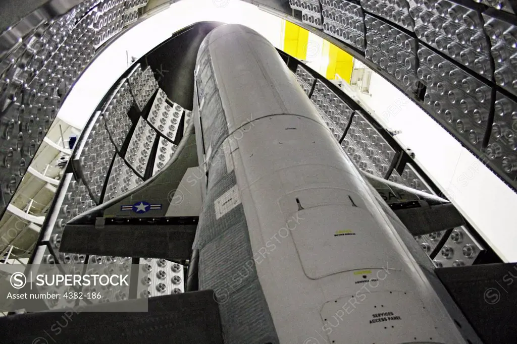 The X-37B Orbital Test Vehicle in the encapsulation cell at the Astrotech facility in Titusville, Florida. The X-37B  launched April 22, 2010, at Cape Canaveral Air Station. The X-37B is the U.S.'s newest and most advanced unmanned re-entry spacecraft.