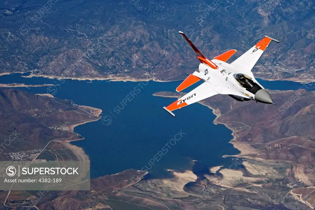 An F-16 Fighting Falcon fitted with radio frequency identification tags flies behind a test tanker on an aerial flight test over Isabella Lake near Edwards Air Force Base, California.  The mission tested the Automatic Receiver Aircraft Identification system on the tanker. (U.S. Air Force photo by Chad Bellay)