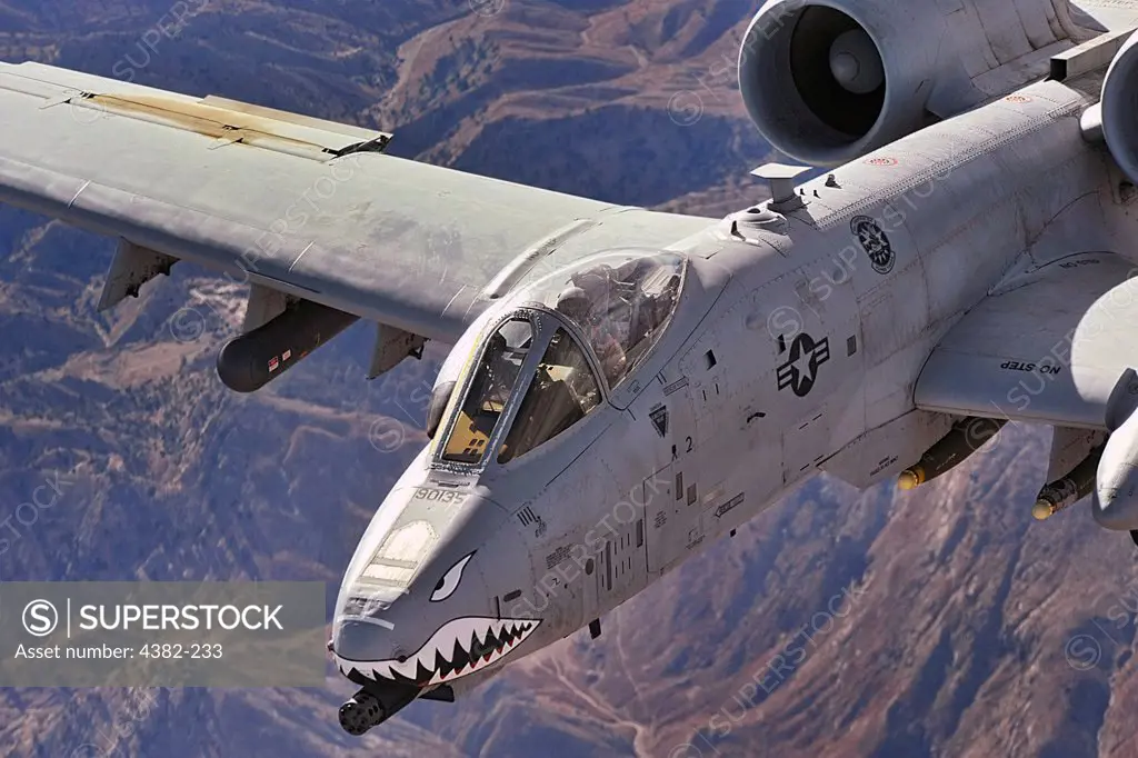 A close-up view of an A-10 Thunderbolt II, also known as a Warthog, in flight over Afghanistan. The cockpit and front-mounted machine-gun are clearly visible. A-10s provide close-air support to ground troops in Afghanistan and Iraq. (U.S. Air Force by photo by Staff Sgt. Aaron Allmon)