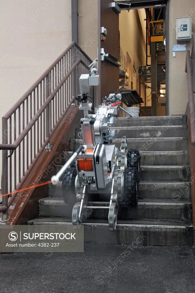 An F6A robot, used by explosive ordnance disposal Airmen with the 51st Civil Engineer Squadron at Osan Air Base, South Korea, prepares to remove a suspicious package at the base post office during a base-wide exercise July 24. (U.S. Air Force photo by Staff Sgt. Lakisha Croley)