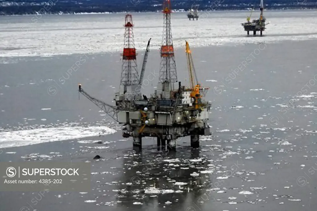 The motor vessel Monarch sinks off of an oil platform in Cook Inlet. The small black object adjacent to the platforms lower left corner is the bow of the vessel.  The vessel reported taking on water at approximately 5:51 a.m. Thursday while located at the Granite Point oil platform in Cook Inlet near Nikiski, Alaska. The vessel sank completely by about noon. (Coast Guard photo/PA1 Sara Francis)