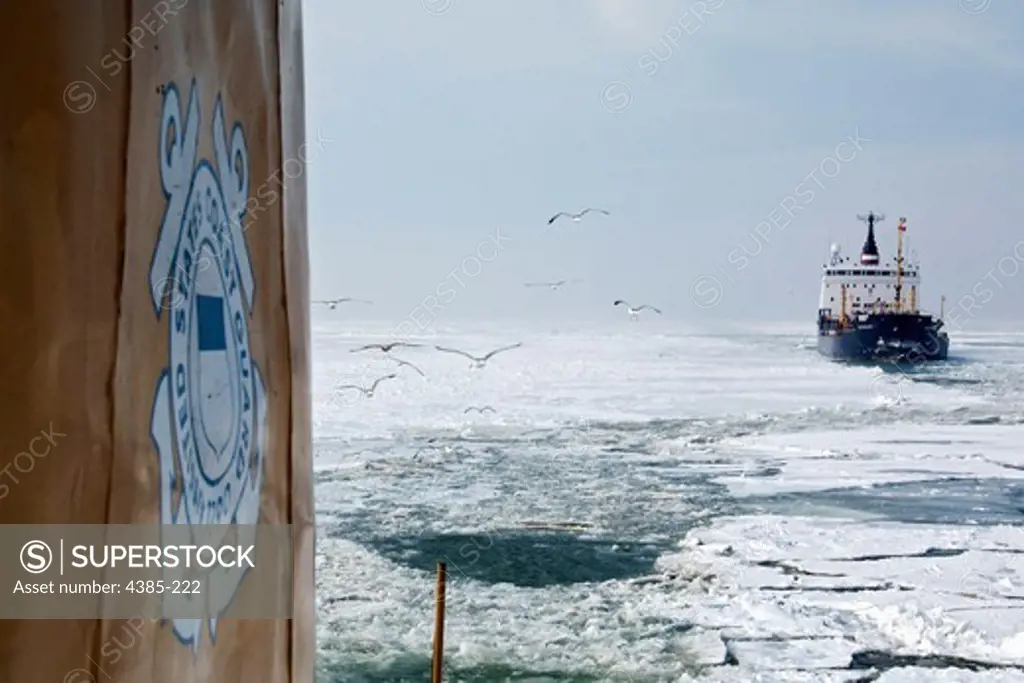 The Coast Guard Cutter 'Neah Bay' escorts a Canadian bulk carrier along Lake Erie east toward Nanticoke, Ontario for Operation Coal Shovel. (U.S. Coast Guard/Photo by Petty Officer Bill Colclough)