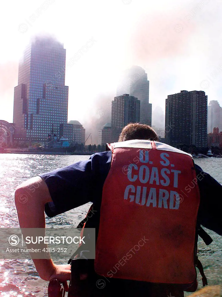 NEW YORK, New York (Sept. 11)--Coast Guard Petty officer Billy Bashaw, from Station Fire Island, bows his head in sorrow onboard his rescue boat Sept. 11.  Bashaw has close friends who work in the World Trade Center who are still unaccounTed for.  USCG photo by PA2 Tom Sperduto
