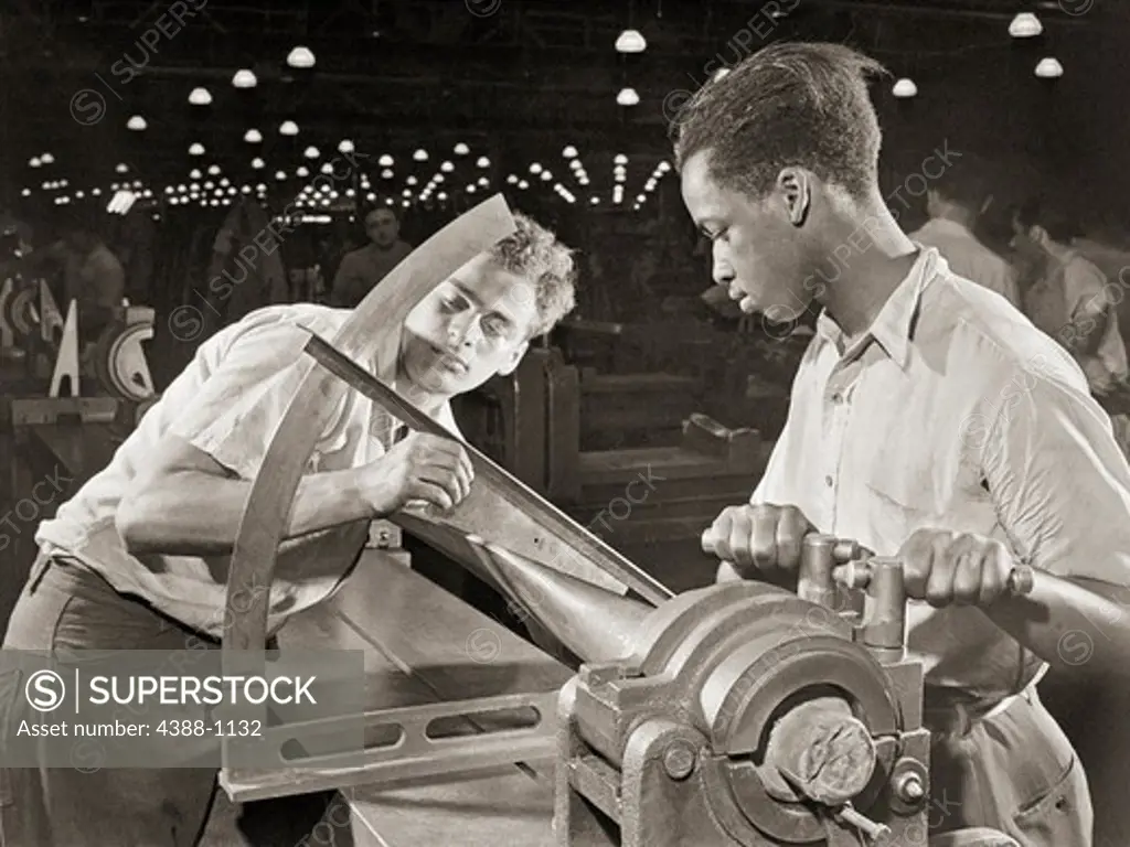 Two Men Operate a Large Machine, Measuring Carefully