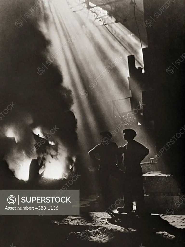 Two Men Stand Silhouetted in a Shaft of Light