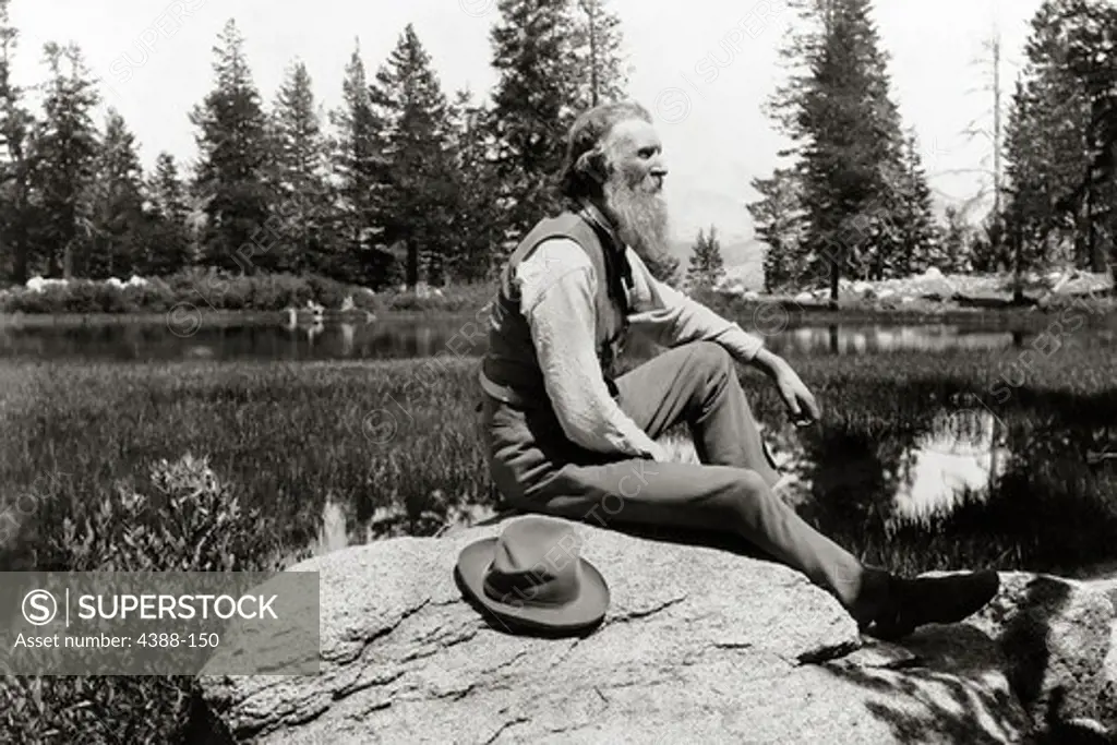 Naturalist John Muir Sitting by Lake