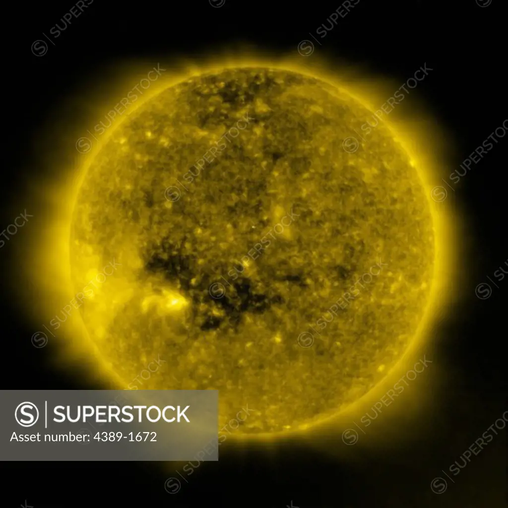 The dark coronal hole in the Sun is a 'open' magnetic area through which the solar wind follows, seen in this view from the Solar and Heliospheric Observatory (SOHO)'s Extreme ultraviolet Imaging Telescope (EIT) 284 Angstrom instrument.