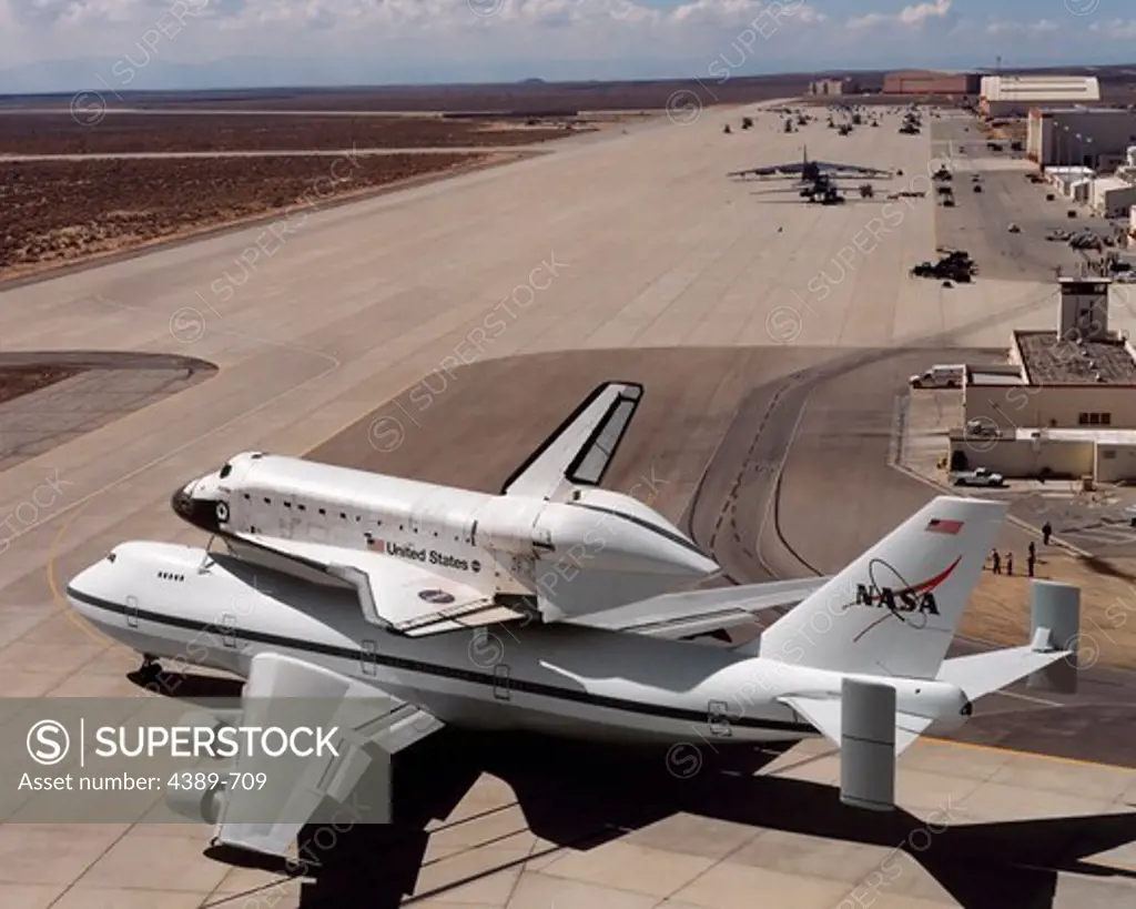 Space Shuttle and Carrier Taxing to Runway