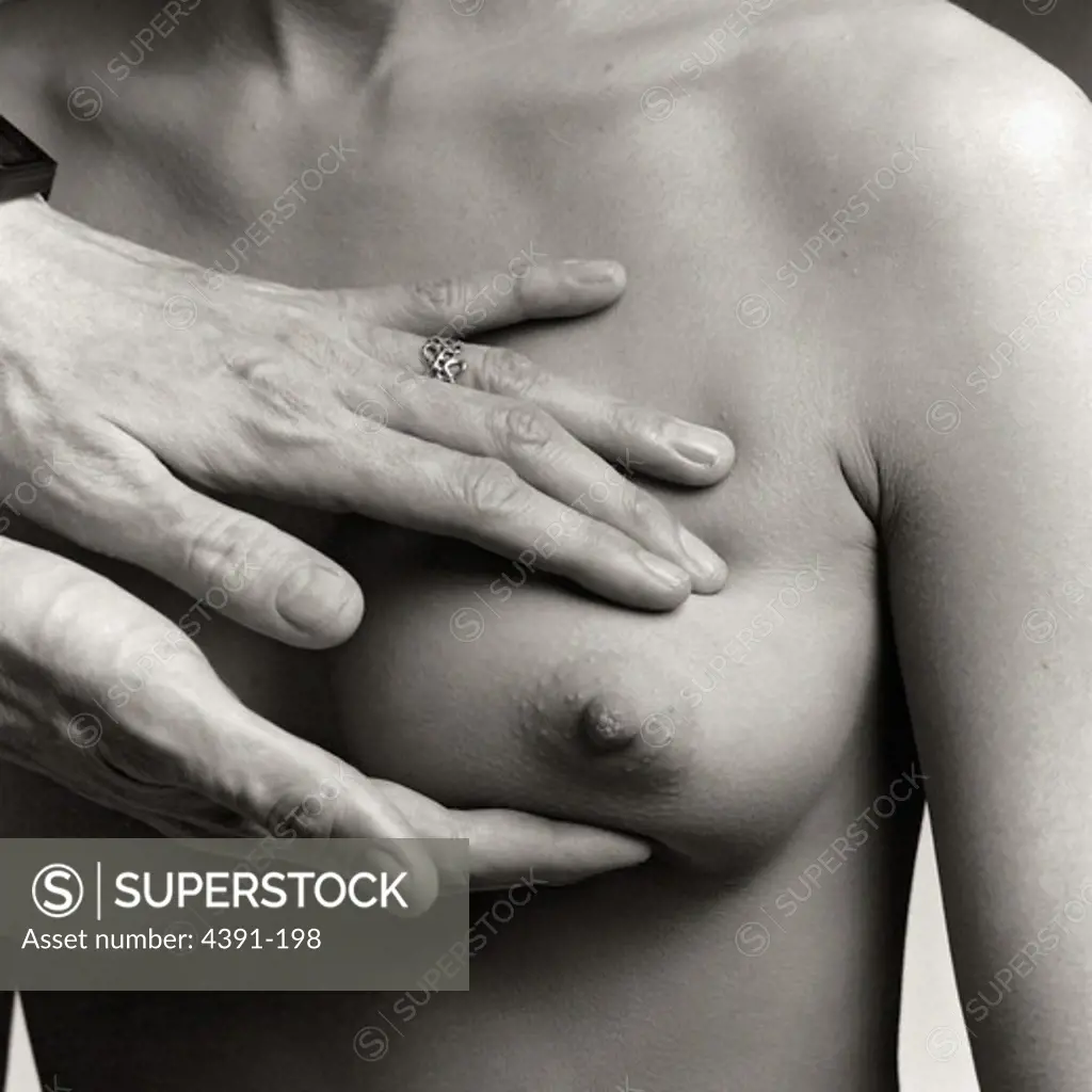 A doctor examines a woman's breast.