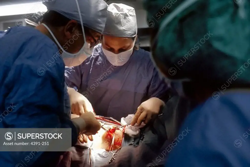 A woman is operated on, her nipple being incised by the surgeon. A surgical biopsy is being performed to determine exact nature of solid tumor. Photo by Linda Bartlett.