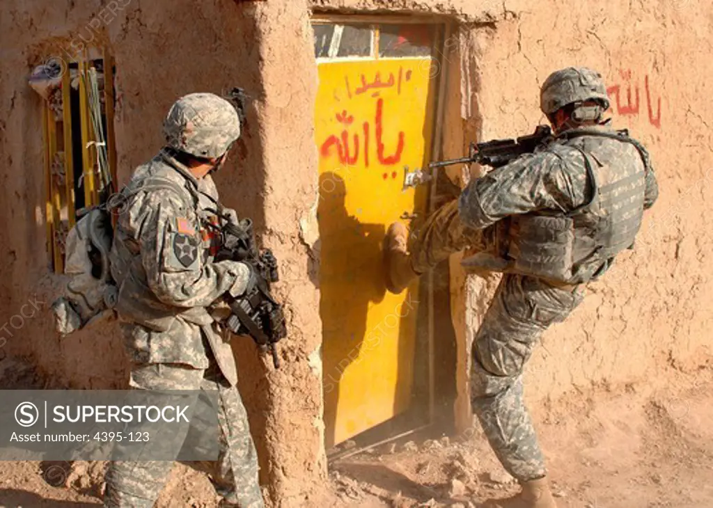 U.S. Army Soldiers with 2nd Squadron, 1st Cavalry Regiment breach a door during a clearing mission in Galahbia in the Diyala Province, Iraq, Dec. 23, 2007. (U.S. Navy photo by Petty Officer 1st Class Sean Mulligan) (Released)