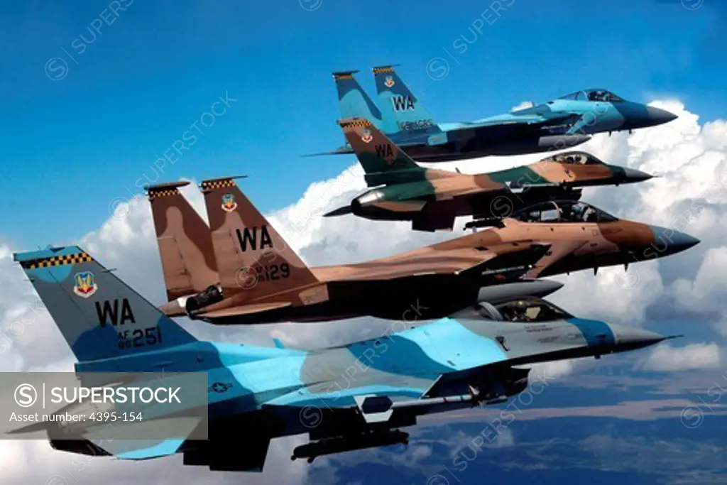 A flight of Aggressor F-15 Eagles and F-16 Fighting Falcons fly in formation 5 June over the Nevada Test and Training Ranges. The jets are assigned to the 64th and 65th Aggressor squadrons at Nellis Air Force Base, Nev.